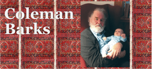 Elderly man with a baby in front of a red Persian rug.