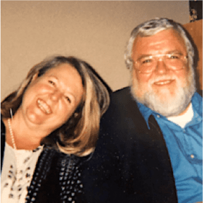 A happy older couple smiling together for a photo.