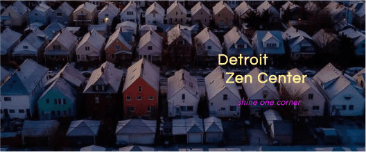 Snow-covered houses in Detroit at dusk, showcasing urban winter tranquility.