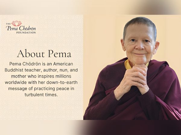 Portrait of Buddhist teacher Abbot Pema smiling warmly in maroon robes.