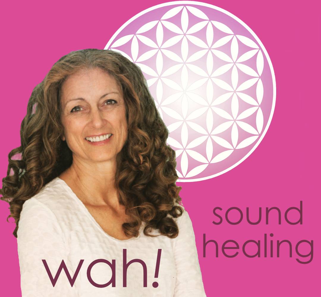 Smiling woman with curly hair and sound healing symbol.