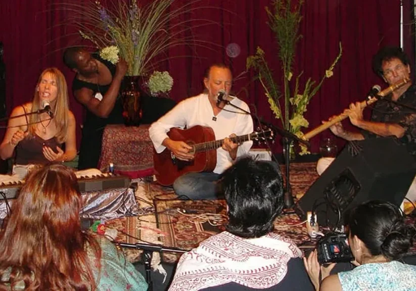 Musicians performing on stage with instruments.